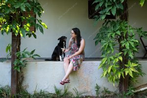 uma pessoa e um cachorro sentados na varanda. vida de cachorro é parte de outras estórias por Ca Mila